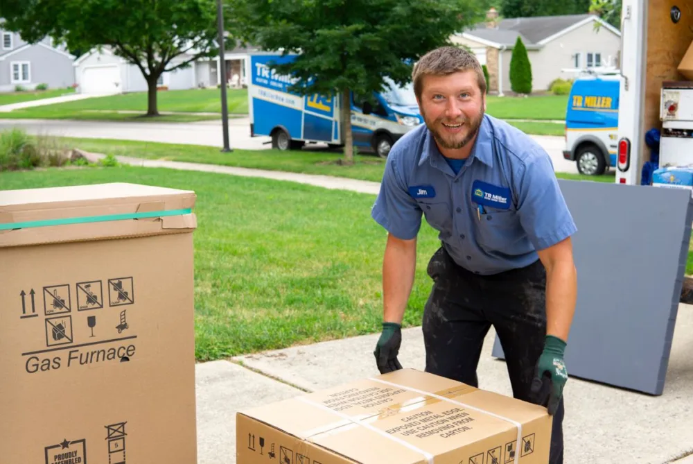 tr miller hvac technician delivering a gas furnace in the chicago suburbs