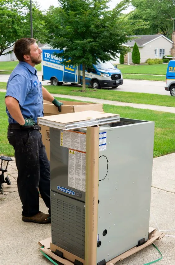 TR Miller technician delivery a new AC unit for a brand new HVAC installation
