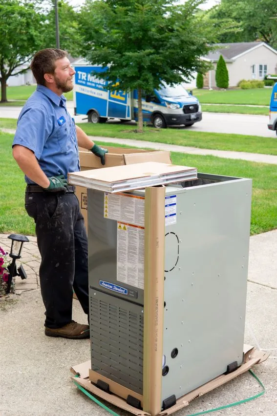 tr miller hvac technician delivering an HVAC unit to a home in the western Chicago suburbs