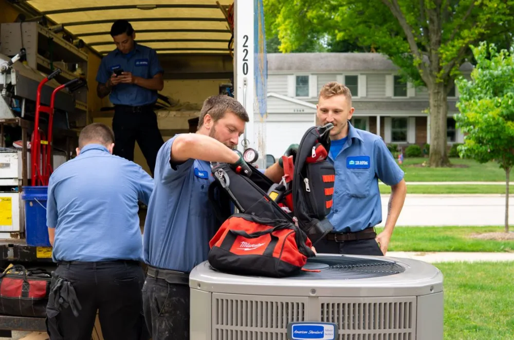 tr miller HVAC contractors installing an air conditioner in the western Chicago suburbs. 