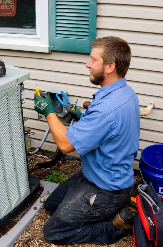 tr miller hvae technician repairing an ac unit in chicago suburbs