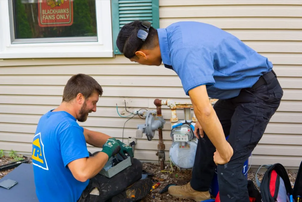 tr miller technicians installing a new air conditioner in the chicago suburbs