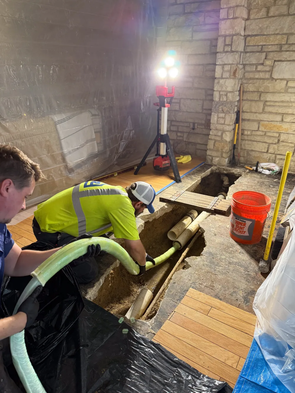 tr miller sewer repair technicians working in a chicago suburban basement