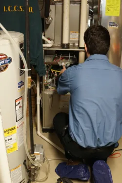 hvac technician working on a residential air conditioning unit