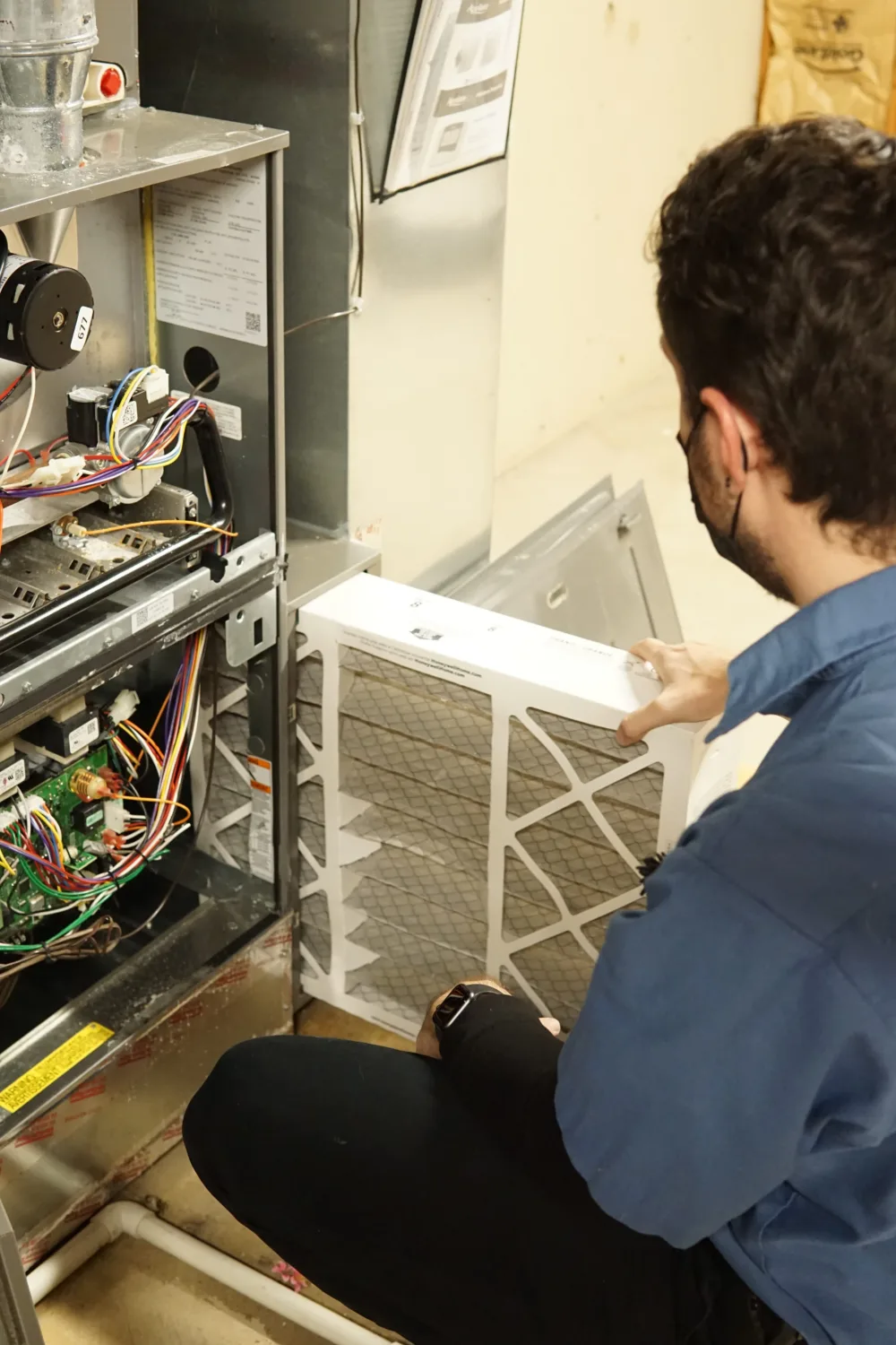 hvac technician performing a filter change in the chicago suburbs