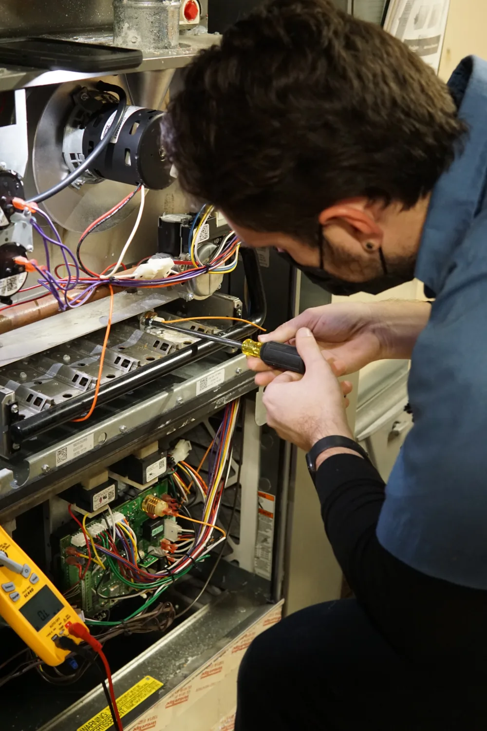 TR Miller performing electrical repairs in a western Chicago suburban home