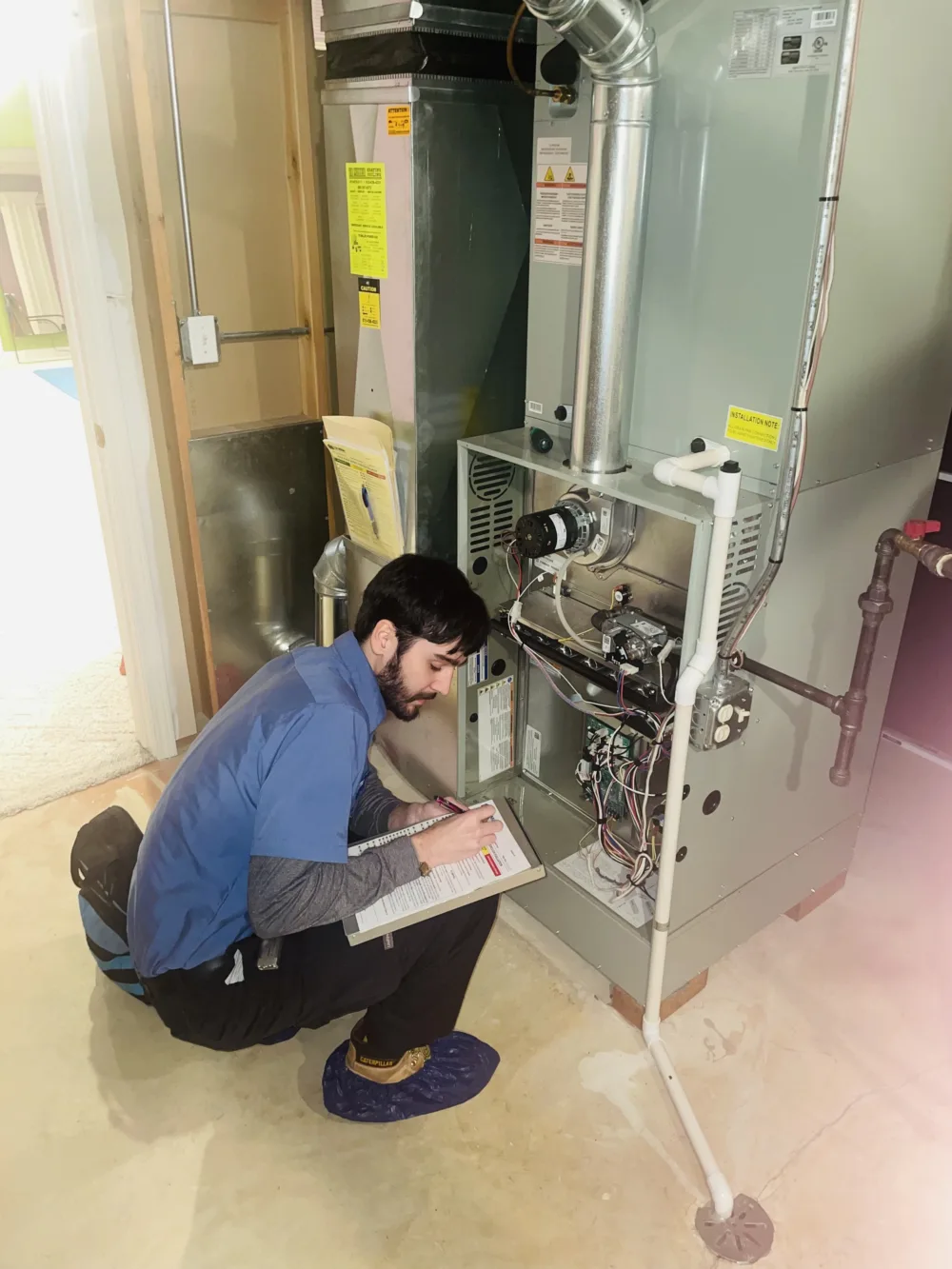 hvac technician performing a furnace tune up in chicago suburbs