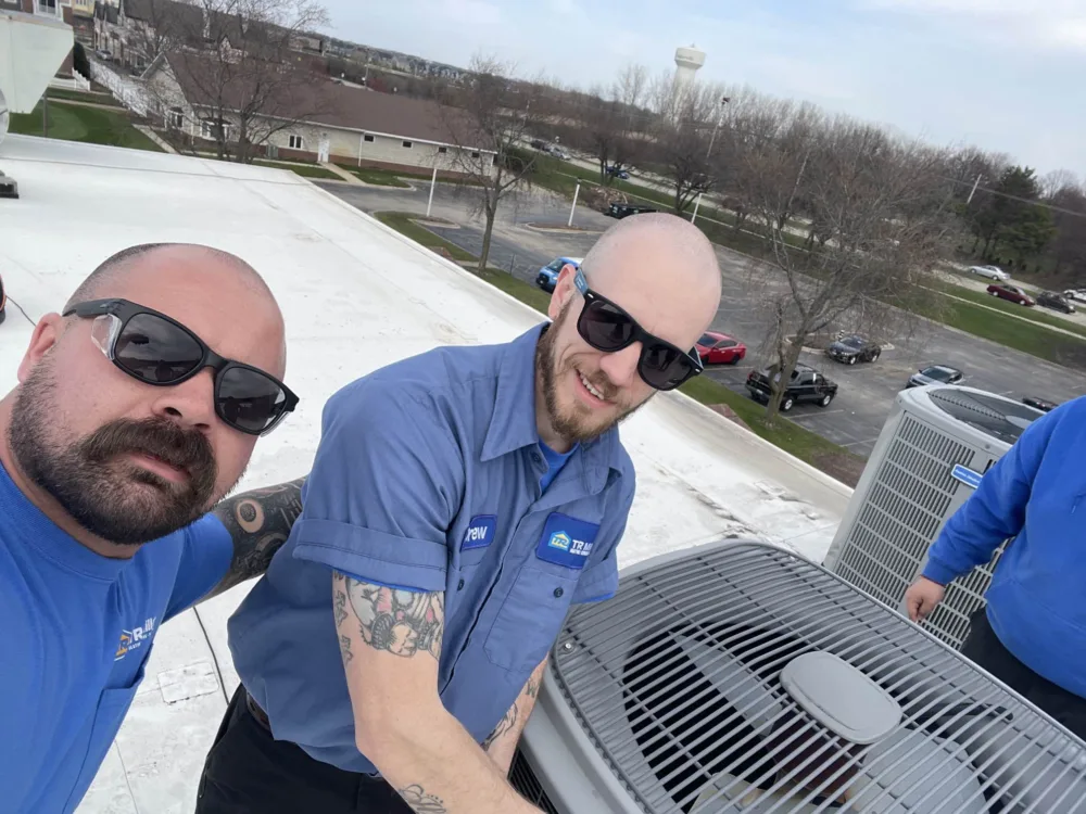 tr miller technicians repairing residential ac units in the western chicago suburbs