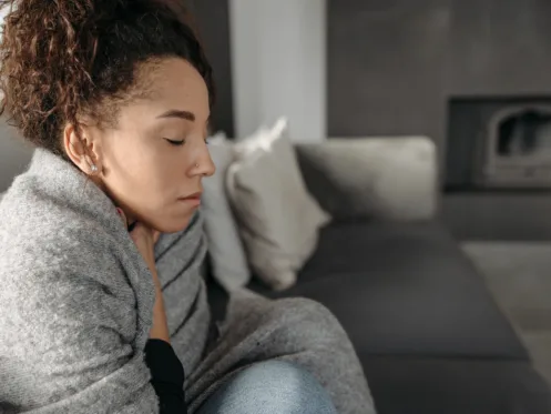 homeowner sitting uncomfortably in a cold home