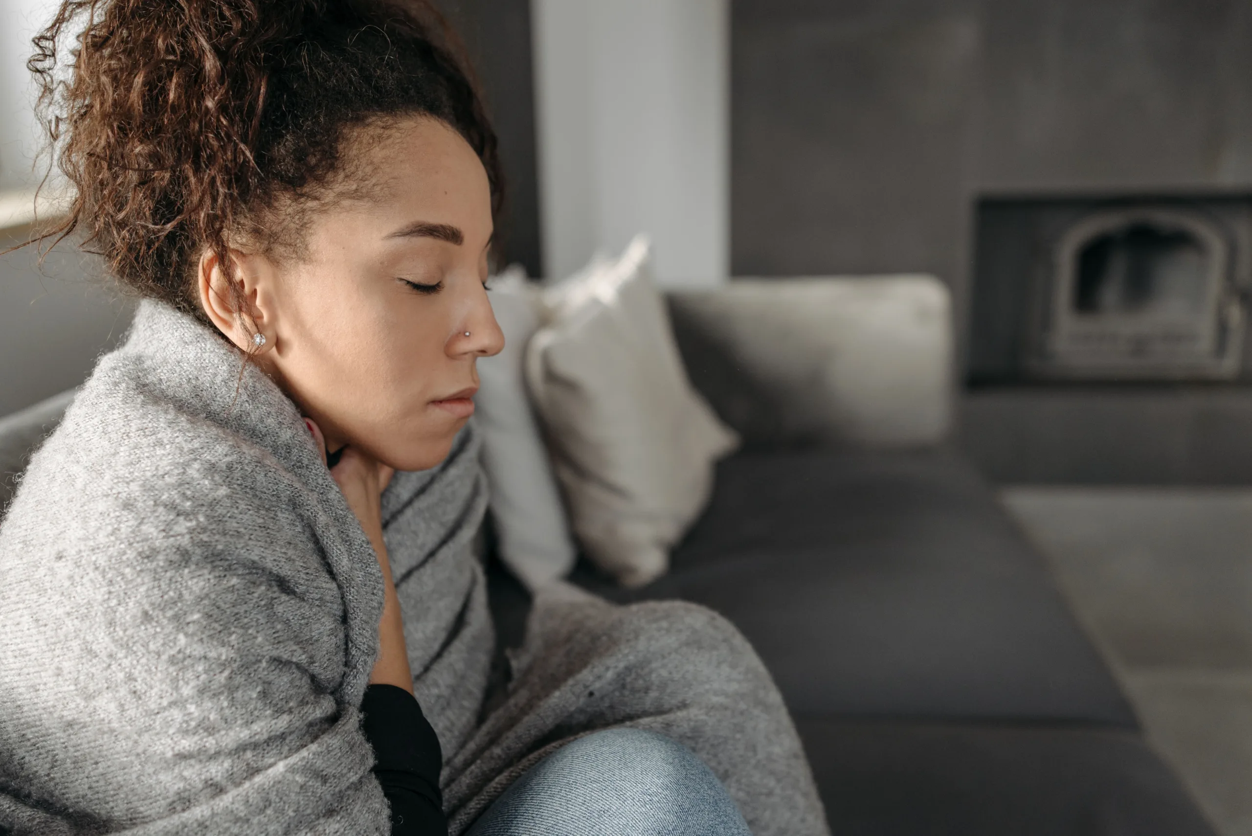 homeowner sitting uncomfortably in a cold home