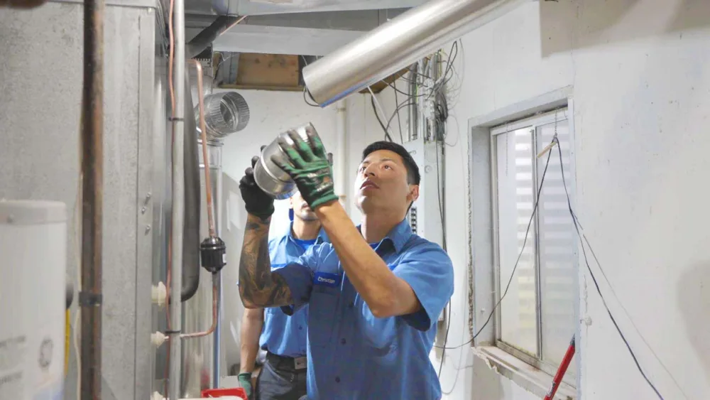 tr miller technician installing a new hvac system in a residential home in chicagoland suburbs