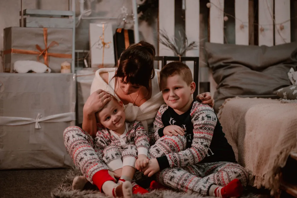a cozy and warm family relaxing with festive holiday pajamas