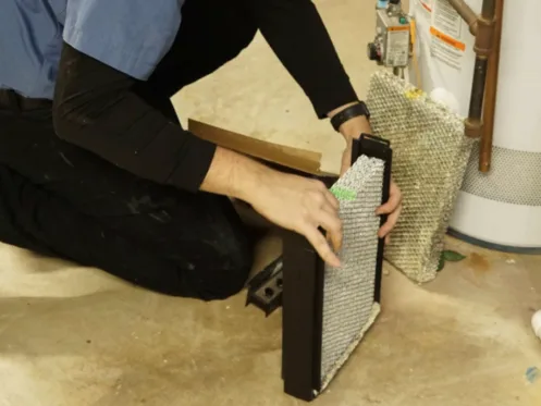 tr miller technician changing a furnace filter