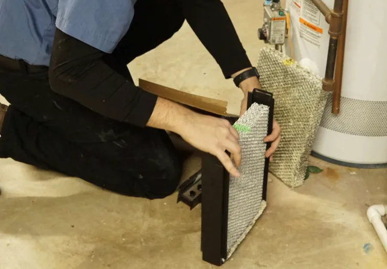 tr miller technician changing a furnace filter