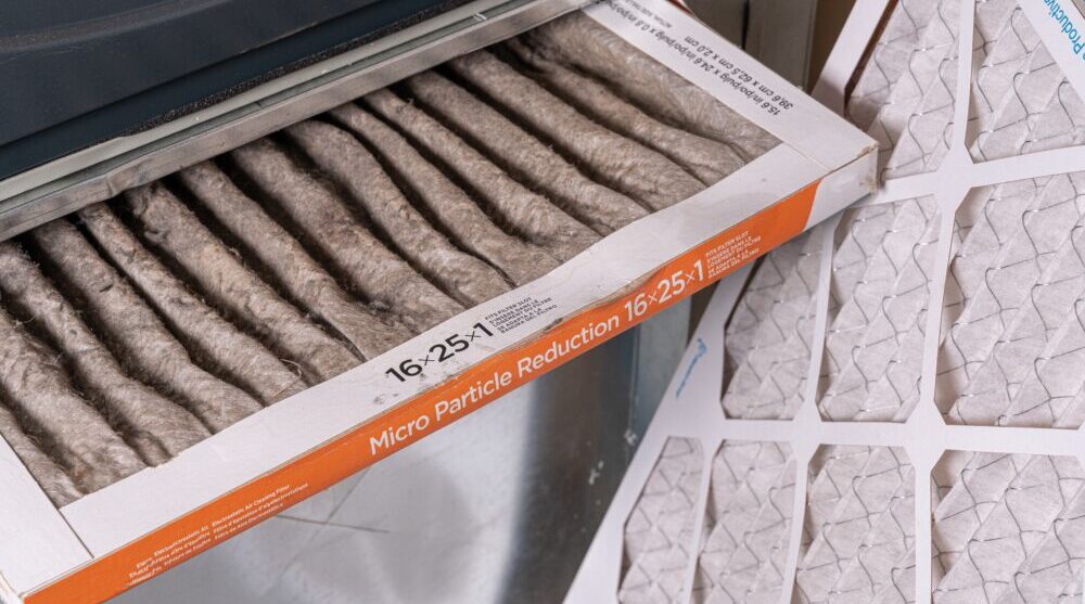 Replacing dirty furnace filter in home