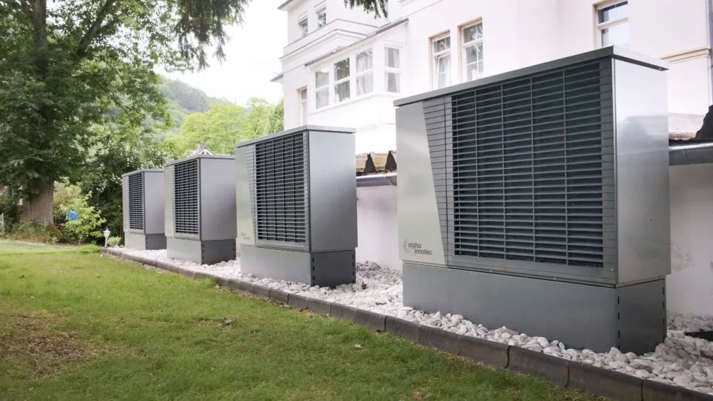 a row of residential heat pumps
