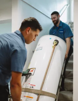 TR Miller plumbers delivering a new tankless water heater to a home in the western chicago suburbs