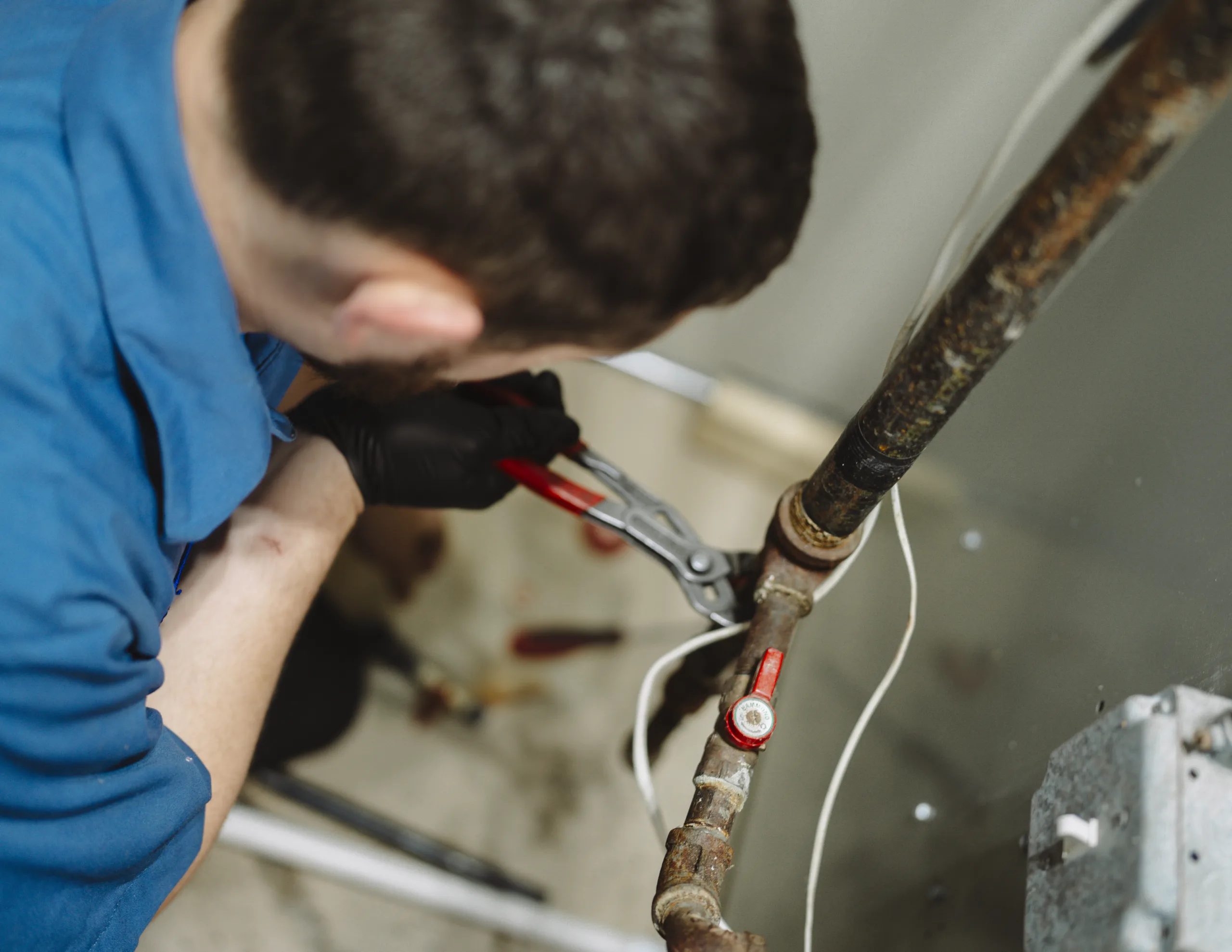 TR Miller technician performing plumbing repair to correct low water pressure